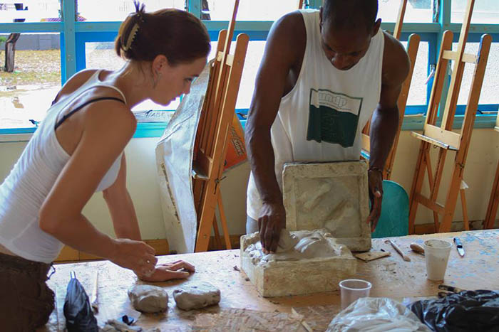 Robin de Vogel assisting Mark King with his mold. Photograph by Omar Kuwas.